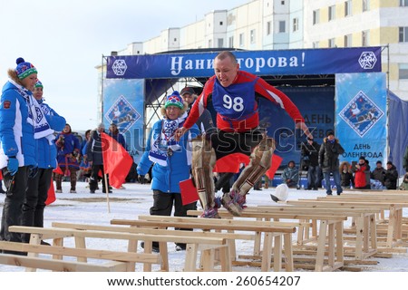 NADYM, RUSSIA - MARCH 14, 2015: competitions in the Nenets national sport - jumps through sledge on a traditional holiday \