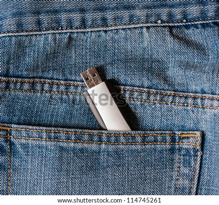 USB data storage drive with protective information pocking out of Jeans pocket. Risk of Identity theft or pickpocket