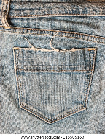 Torn worn out pocket of old Blue jeans