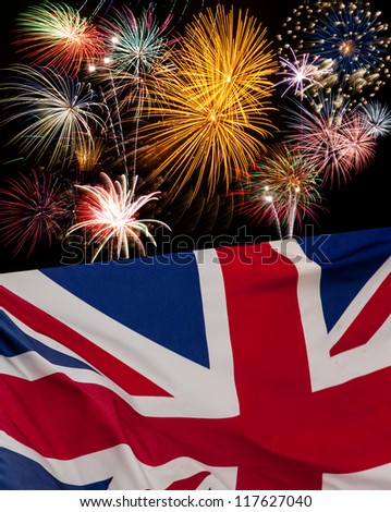 UK Holiday concept with fireworks and waving UK flag .