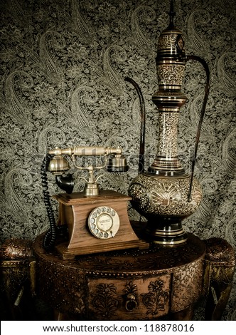 Antique Classic Furniture With Old Retro Phone And Indian Arabic Tea Pot On A Retro Elephant Styled Desk