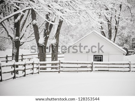 Old farm in the winter with heavy fog. Winter wonderland.