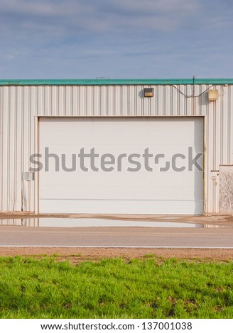 Industrial warehouse and workshop entrance of a factory with approach road