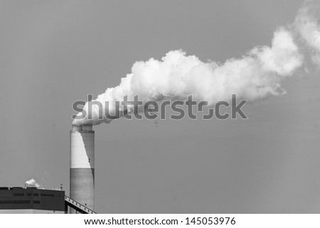 Monochromatic image of Industrial power plant with smokestack. Pollution generated by coal fired power plant.