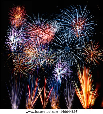 Firework streaks in the night sky. Spectacular pyrotechnic show by professional team
