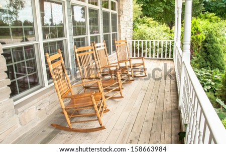 Rocking chairs invite one to relax on an old wooden front porch