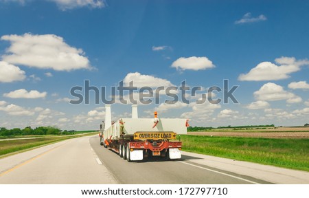 Semi truck on the road transporting oversize load and cargo