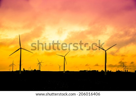 Wind farm at sunset, Alternative energy concept, instagram style retro processing. smart grid