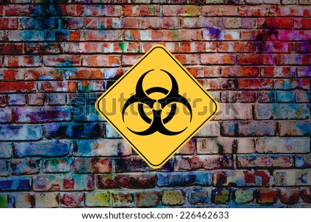 Industrial Waste. Biohazard or Bio Hazard symbol sign on old graffiti wall of defunct factory