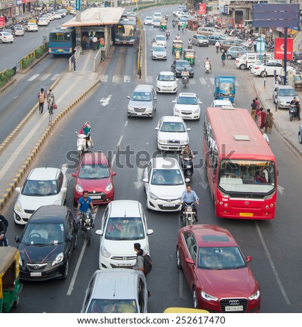 Ahmedabad, India - February 06, 2015: Traffic scene of Ahmedabad, India.  Auto rickshaws and Bus Rapid Transport (BRT) buses provide public transportation.
