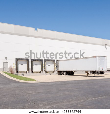 A view of a giant Logistics warehouse with multiple loading docks