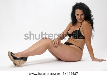 stock photo Suntanned healthy Mature woman in black lingerie and shoes 
