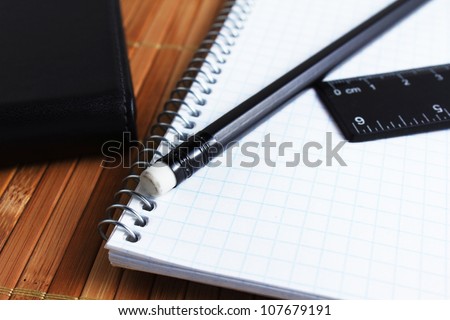 closeup of pen, spiral notebook and ruler