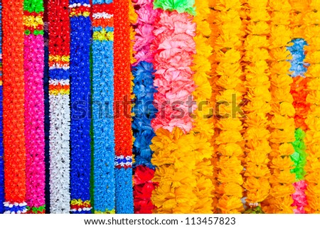 The background image of colorful plastic garlands for worship