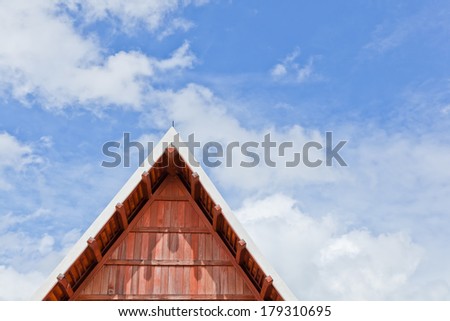 The part of the apex of a gable roof with blue sky