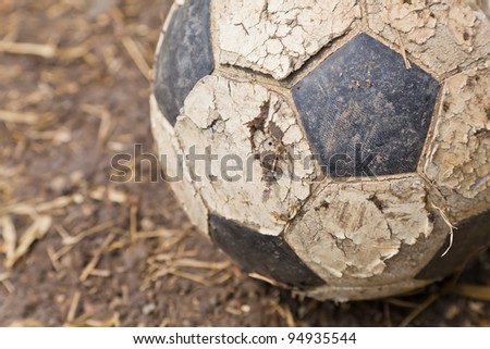 The closeup image of an old ball on the ground