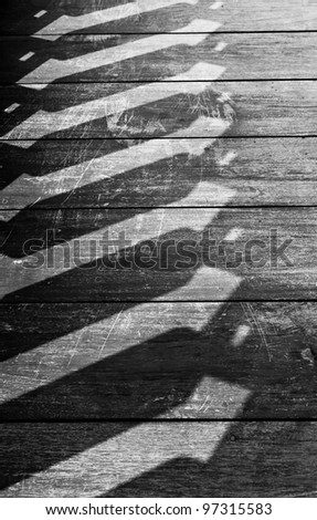 The black and white background image of the old wooden floor and the shadow of a handrail