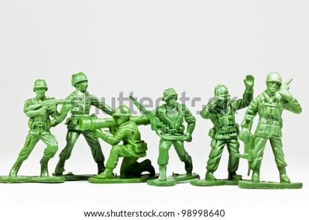 The isolated image of a group of green plastic toy soldiers