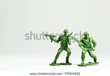 The isolated image of two green plastic toy soldiers