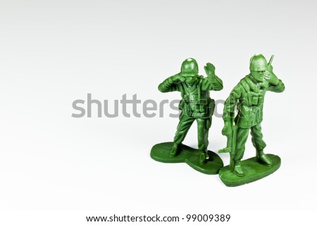 The isolated image of two green plastic toy soldiers