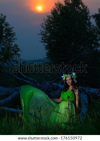 Portrait of a beautiful young woman on background of sunset. Mystic pictures.