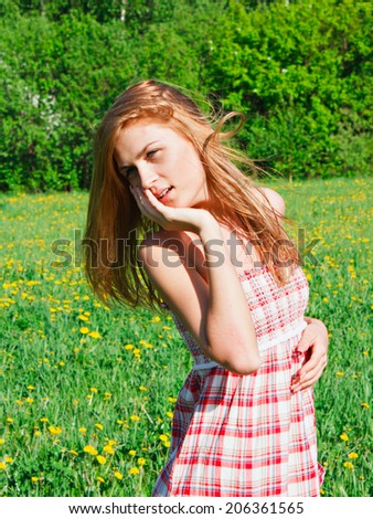 romantic beautiful young woman outdoors,  model in field long hair blowing
