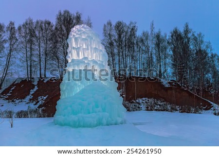 Prodigies of nature: giant icicle in the dusk near Tatinets village. Nizhniy Novgorod region.