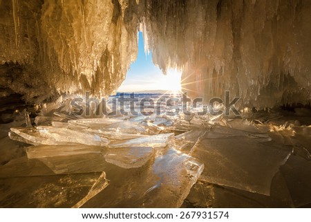 View from cave with icicles and blocks of ice. Baikal lake, Siberia, Russia