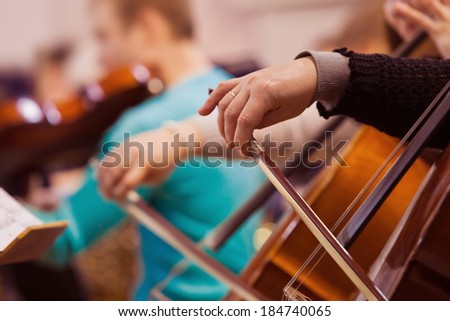 Hand of a woman playing the cello
