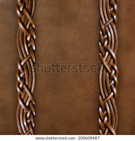 Background of brown leather with braided leather straps