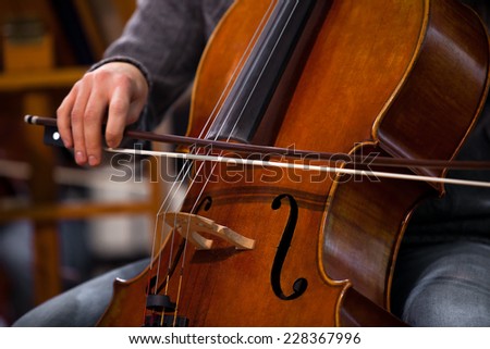 Detail of the cello in the hands of a musician