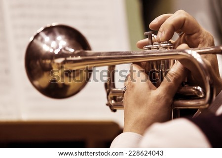 Hands of the man playing the trumpet