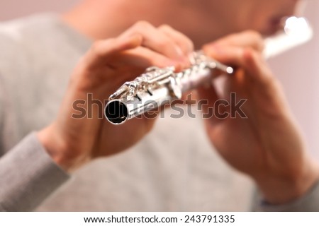 Fragment of flute in the hands of a musician