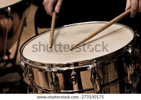 Drum sticks hitting the drum closeup
