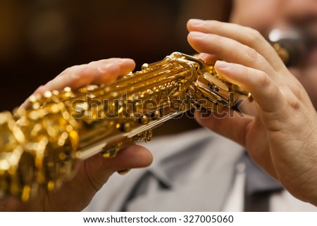 Hand of musician playing the soprano saxophone
