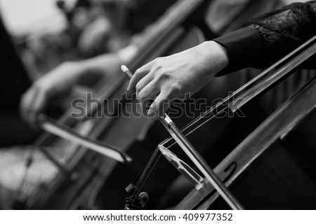 Hand girl playing the cello close up in black and white