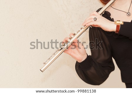 Hand of a woman playing a flute