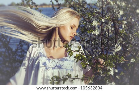 woman smelling flowers and her hair grow