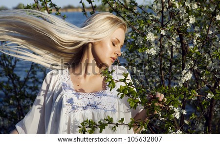 woman smelling flowers and her hair grow