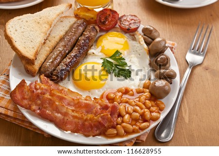 traditional english breakfast - egg, sausages, beans and bacon