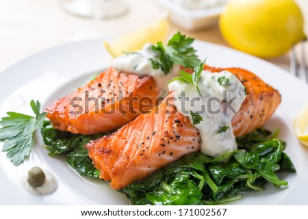 Grilled Salmon Steak  with Spinach, Tartare Cream and Lemon Wedges