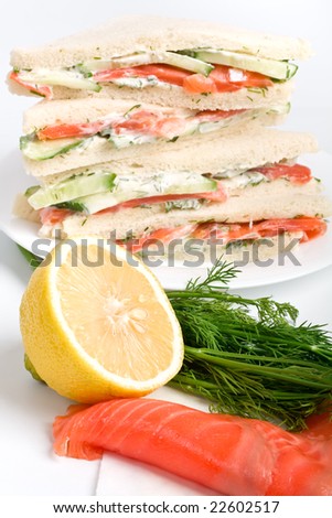 club tea sandwich with salmon and cucumbers on white bread