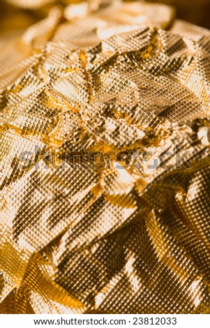crumpled golden chocolate candy wrapper texture