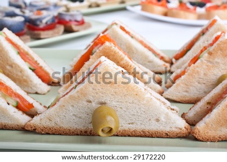 club tea sandwich with salmon and cucumbers on white bread