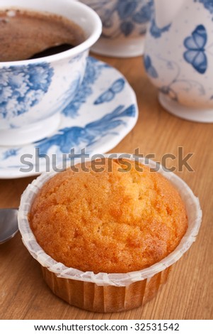 muffin with coffee in white and blue floral  patterned china