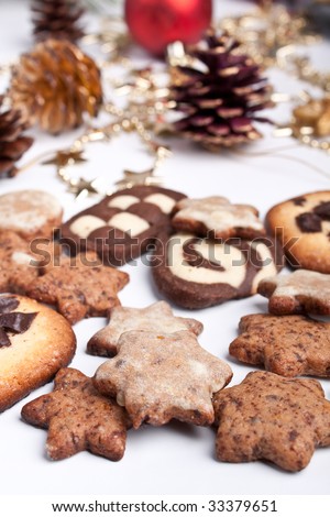 big pile of various cookies with pine cones and christmas decorations