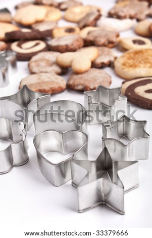 big pile of homemade cookies with various cookie cutters