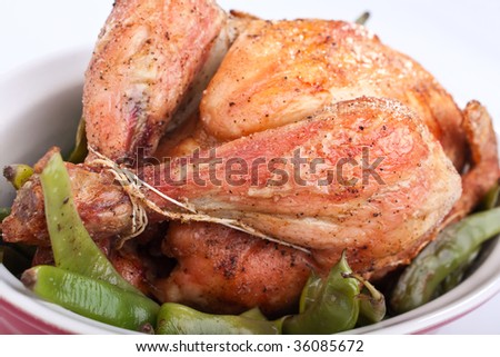 whole roasted chicken with green beans in a dish
