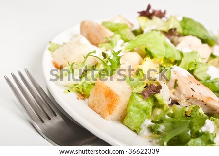 plate of traditional caesar salad with chicken