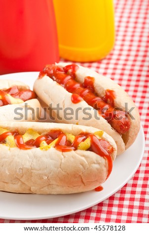 group of hot dogs,  on checked table-cloth table